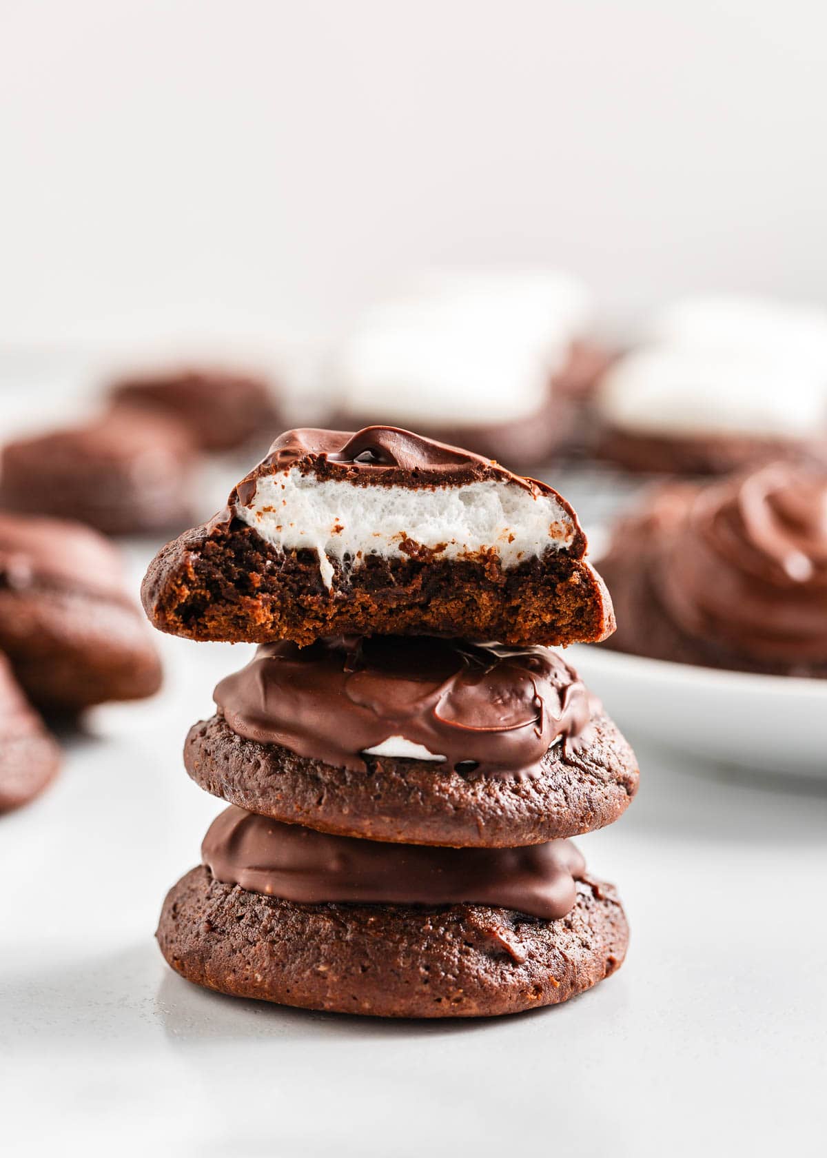 These chocolate marshmallow cookies are fudgy, chewy chocolate cookies topped with gooey marshmallows and melted chocolate. An edible version of a mug of hot cocoa! Chocolate marshmallow cookies with chocolate on top.
