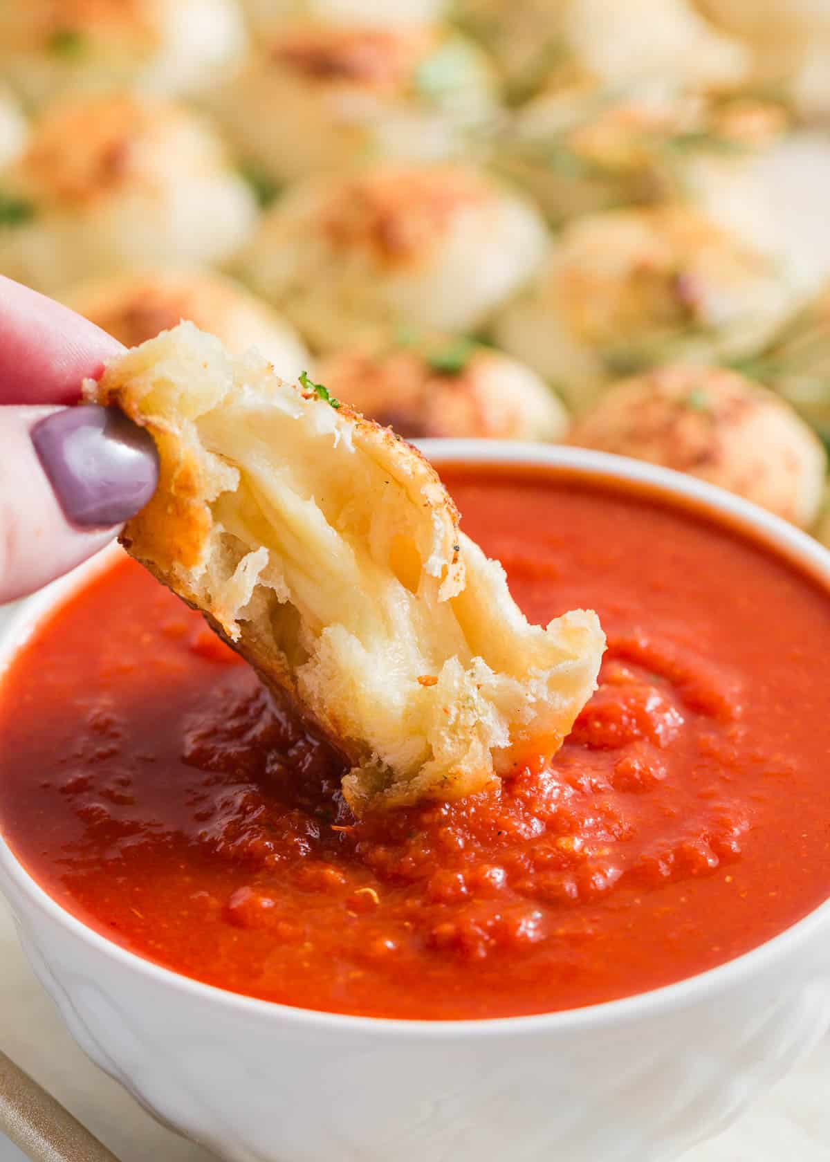 Dipping bread into sauce.