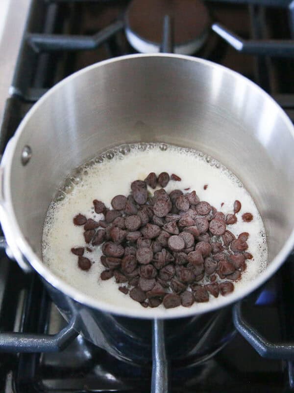 Butter and chocolate chips in a saucepan on the stove.