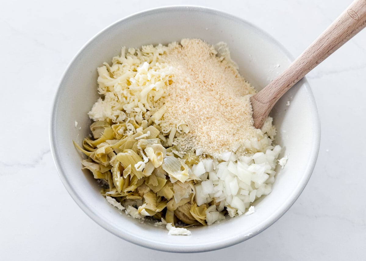 Showing how to make artichoke dip.