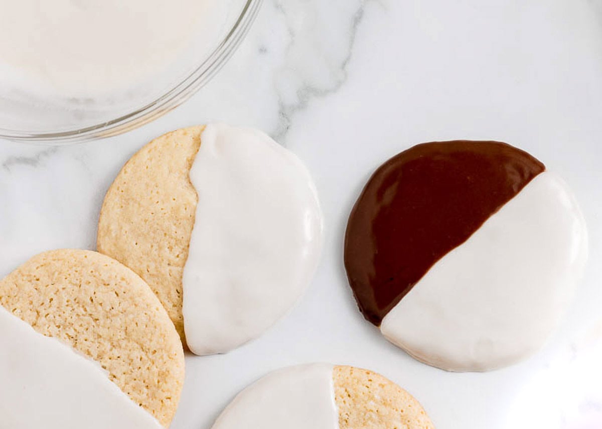 Dipping black and white cookies.