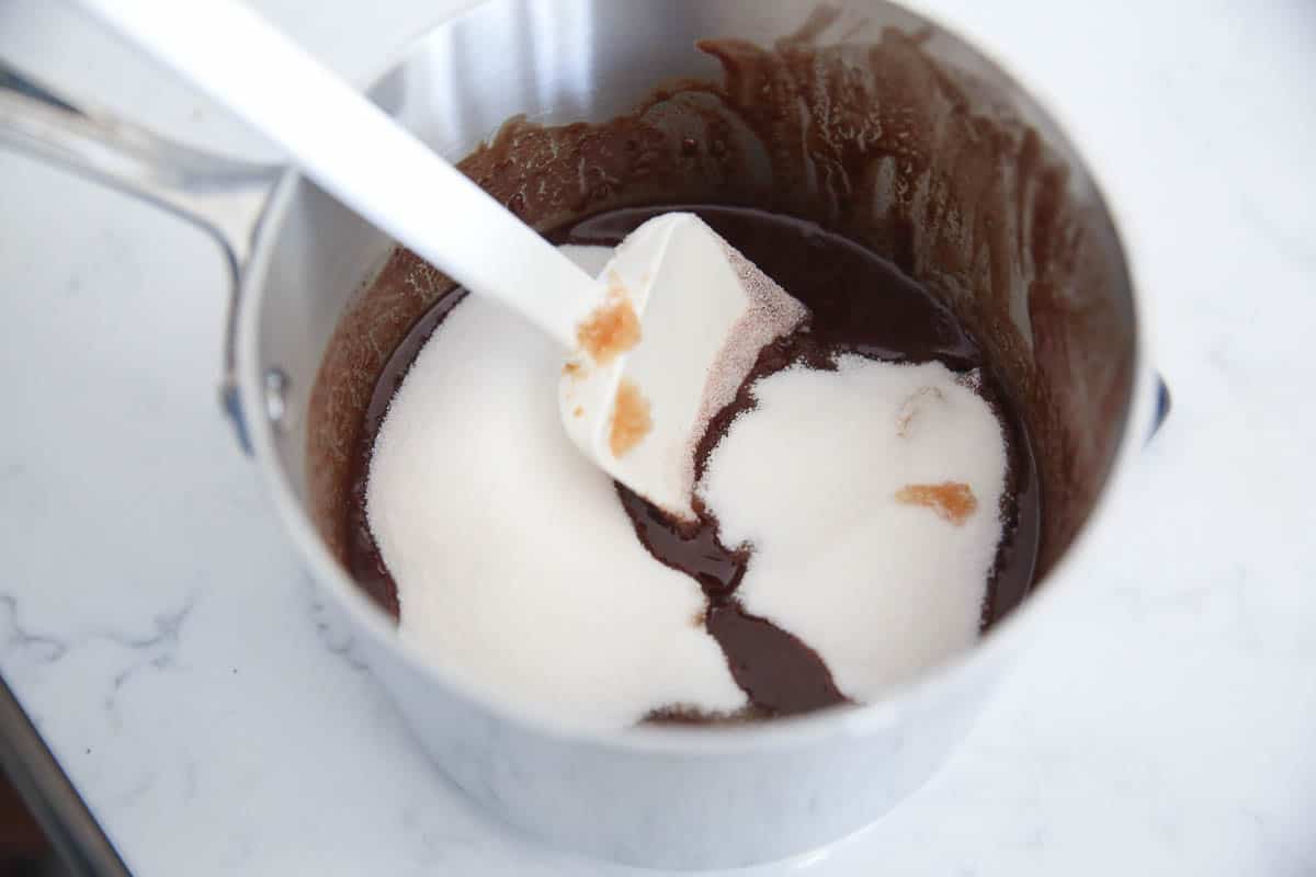 Sugar being stirred into melted chocolate.