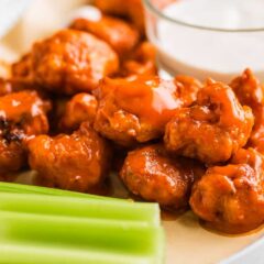 Boneless chicken wings fried to crispy perfection served with dipping sauce and celery.