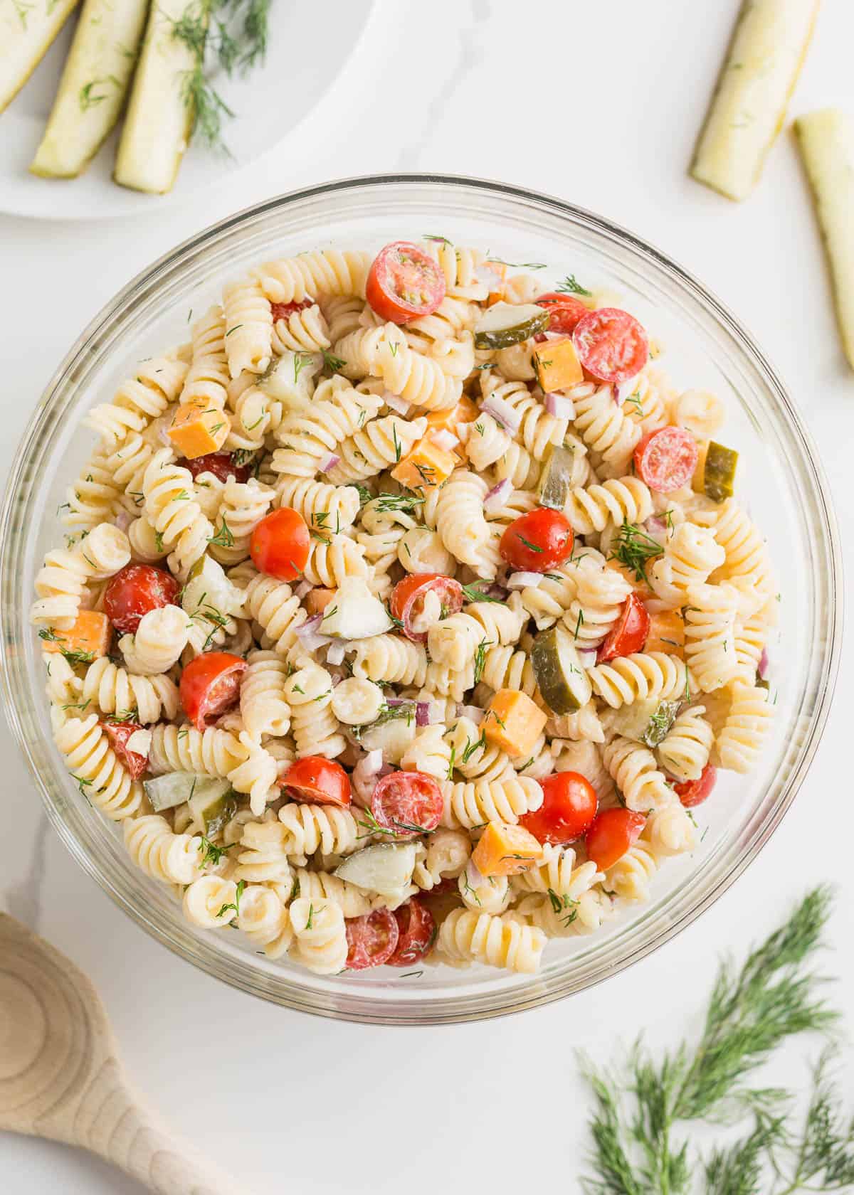 This creamy, briny, and tangy dill pickle pasta salad comes together quickly and can be made the day it's served or, better still, chilled overnight. It's the perfect side dish! A bowl of dill pickle pasta salad.
