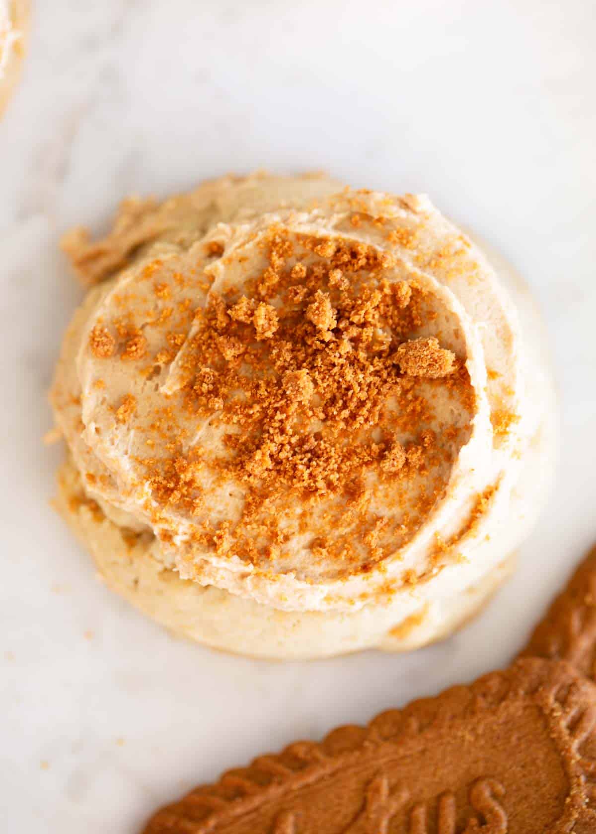 Biscoff cookies are made with a soft brown sugar cookie base then topped with sweet cookie butter frosting and Lotus cookie crumbs. Better than Crumbl cookies!