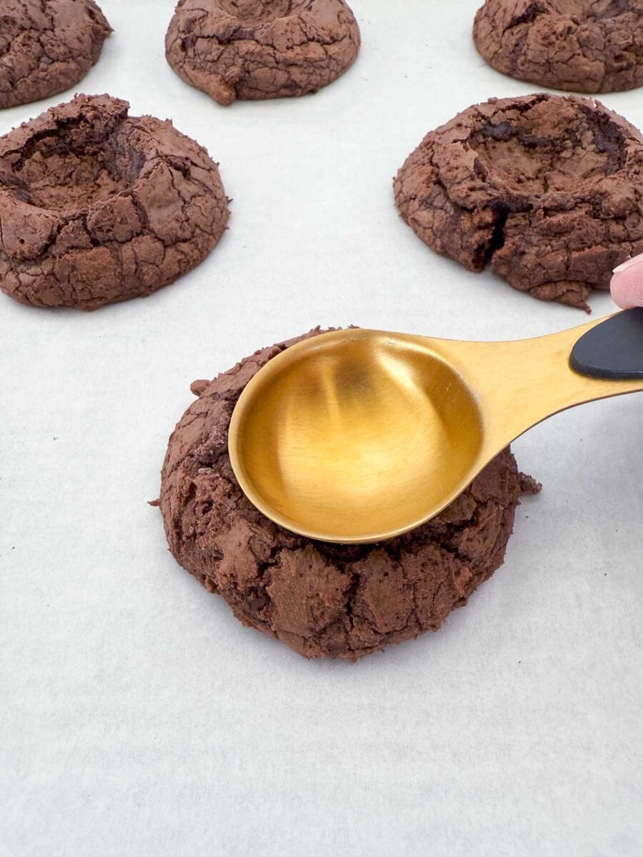 Pressing spoon in cookies.