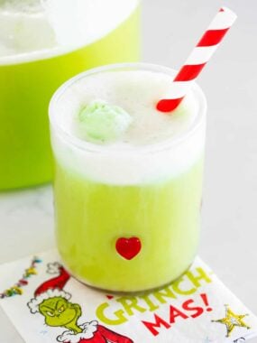 Grinch punch in a glass cup.