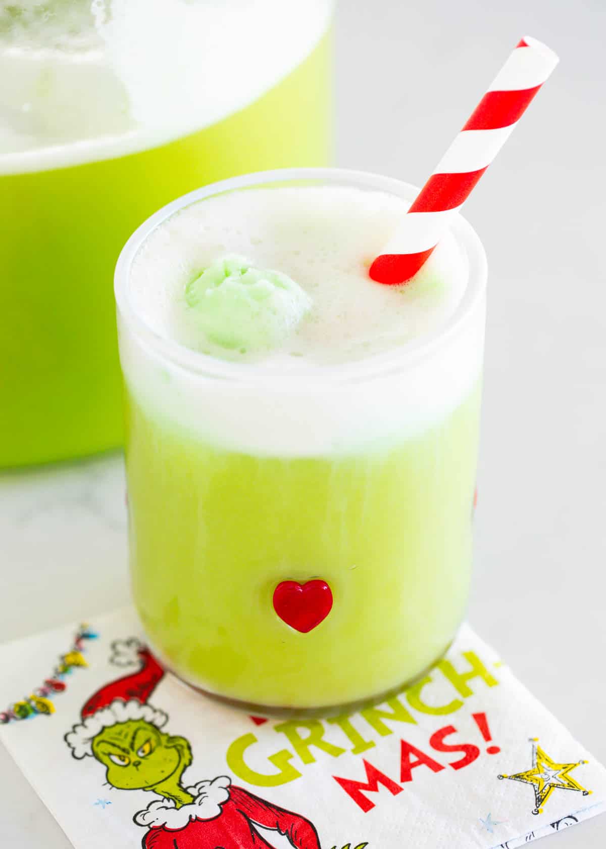 This Grinch punch recipe is a fun and festive holiday punch that the whole family will love. It's so easy to make with only 3 ingredients and perfect for any holiday party! Grinch punch in a glass cup.
