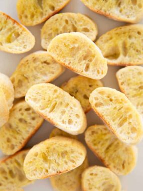 Golden, crispy crostini toasts fresh from the oven made with sliced baguette bread.