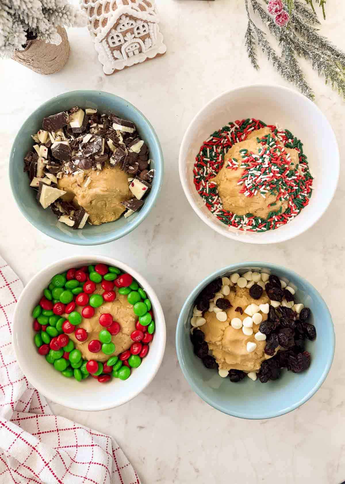 Sheet pan cookie bars add-ins in small bowls.