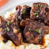 Red wine braised short ribs over mashed potatoes with rich sauce and fresh thyme.