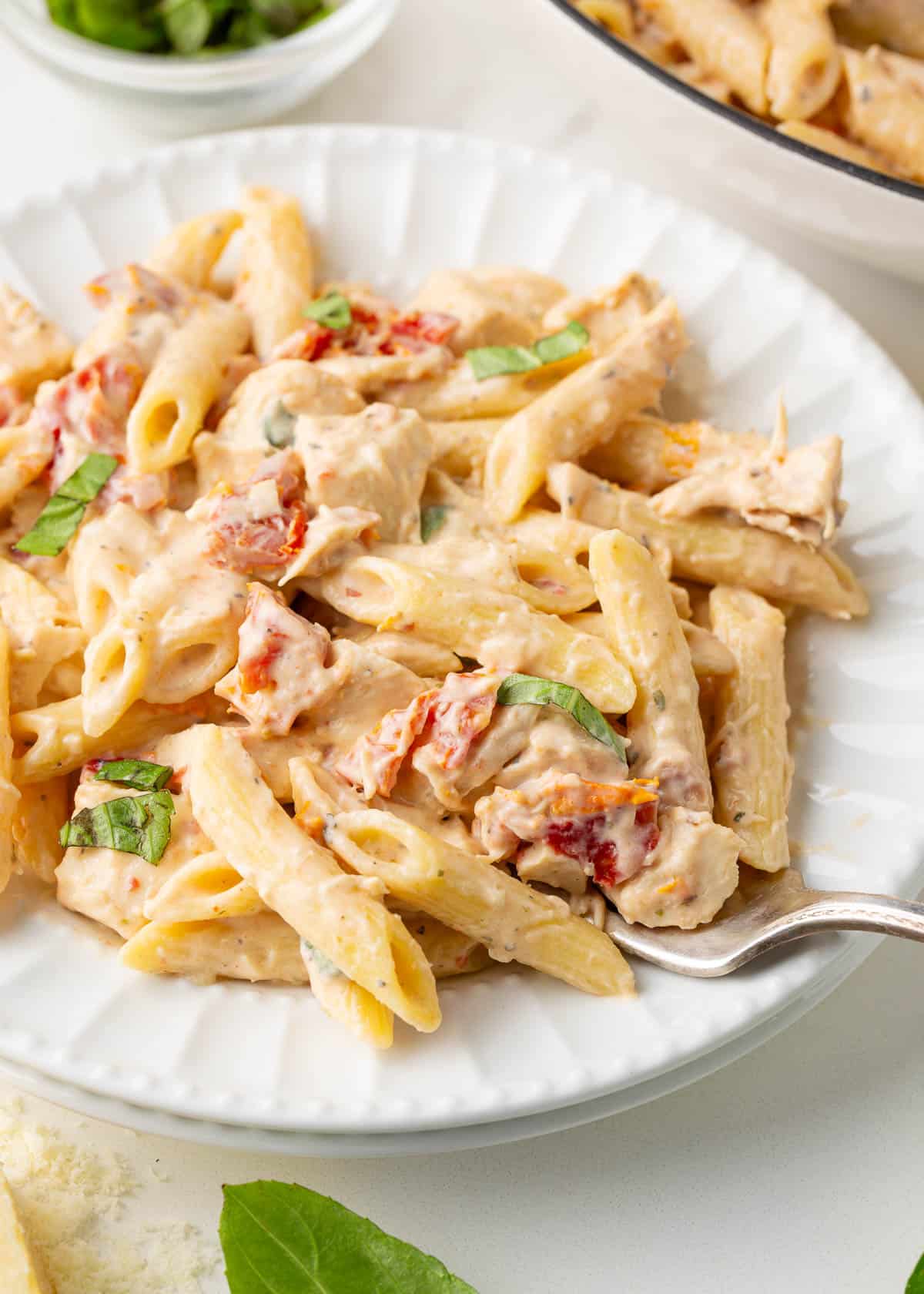 Marry me chicken pasta on a white plate.