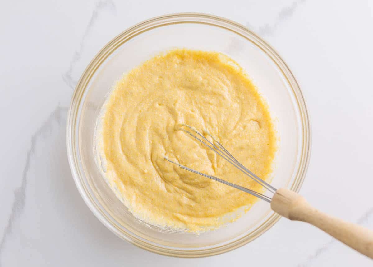 Corn dog batter mixed in a bowl until smooth and thick.
