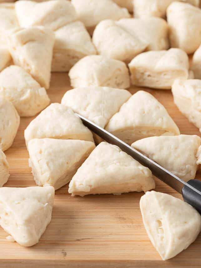 Cutting biscuits into pieces for monkey bread.