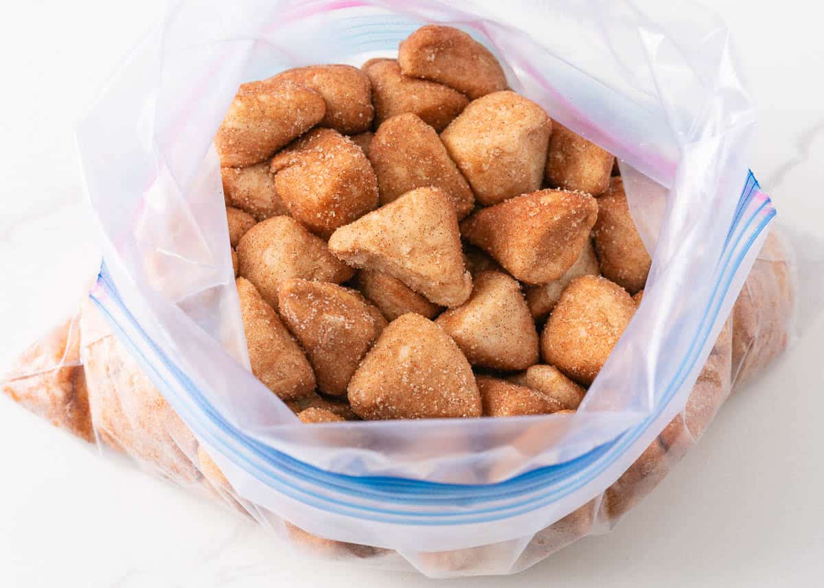 Biscuit pieces in a bag with cinnamon and sugar.