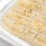 Sourdough dsicard crackers on a baking sheet.