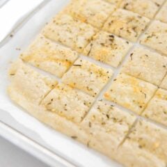 Sourdough dsicard crackers on a baking sheet.