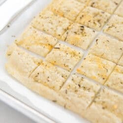 Sourdough dsicard crackers on a baking sheet.