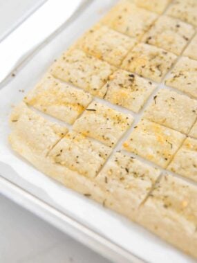 Sourdough dsicard crackers on a baking sheet.