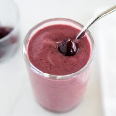 Cherry smoothie in a glass cup.