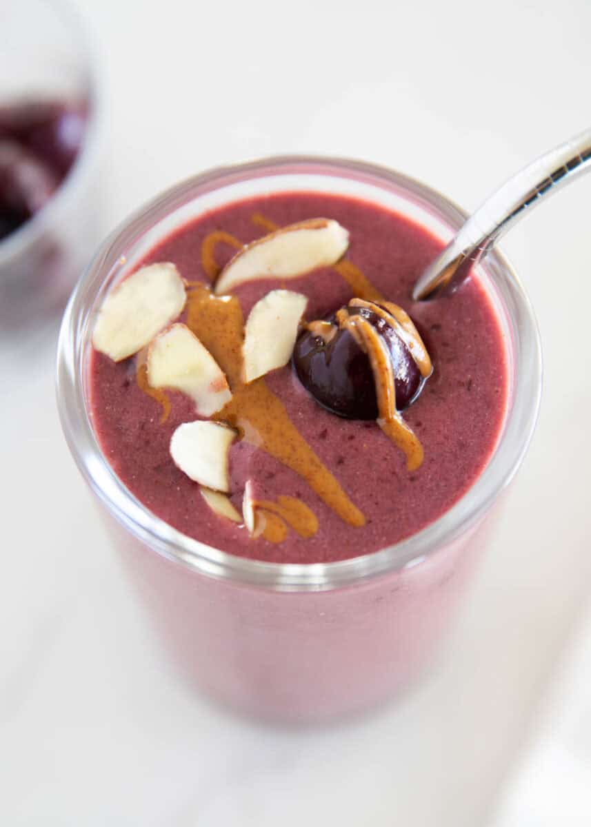 Cherry smoothie in a glass cup.