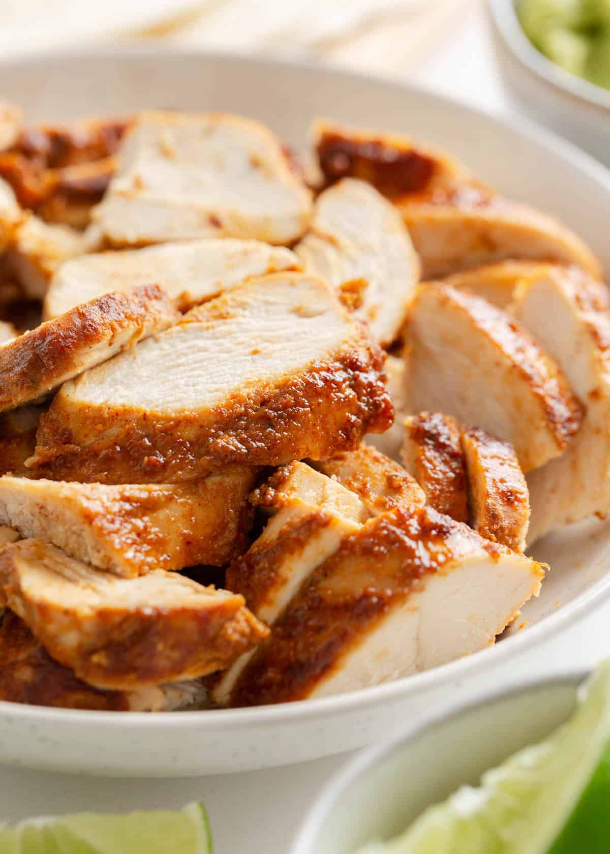 Sliced chipotle chicken in bowl.