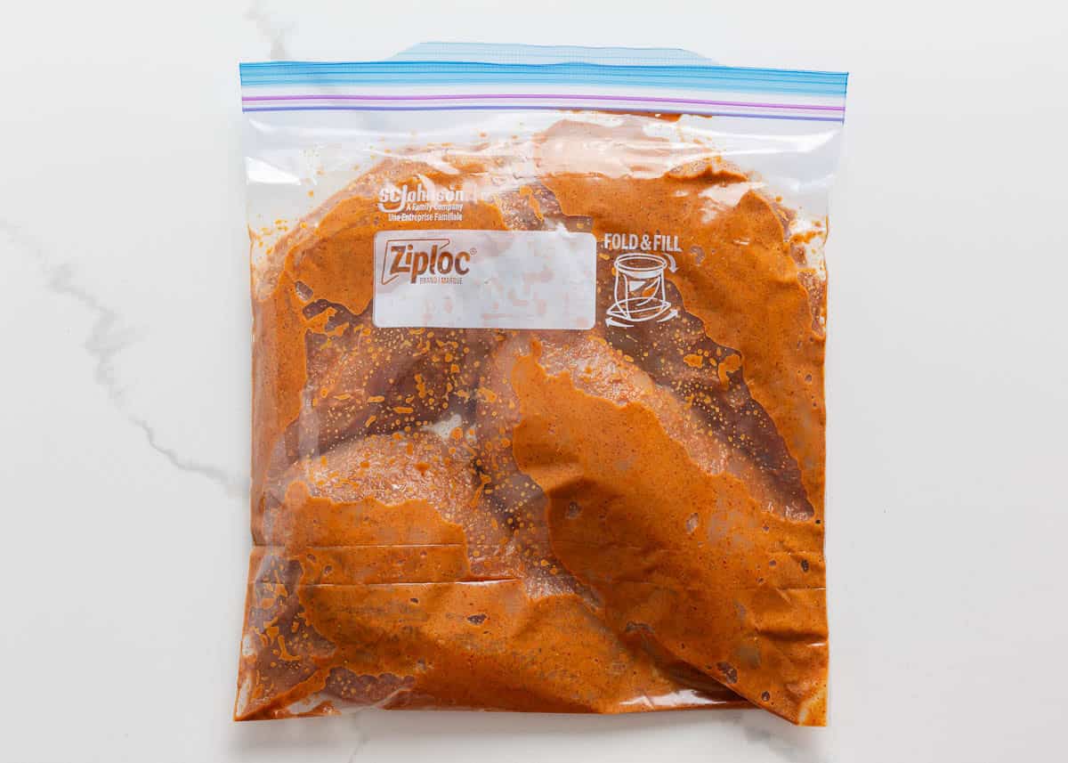 Chipotle chicken marinating in a zip top bag.