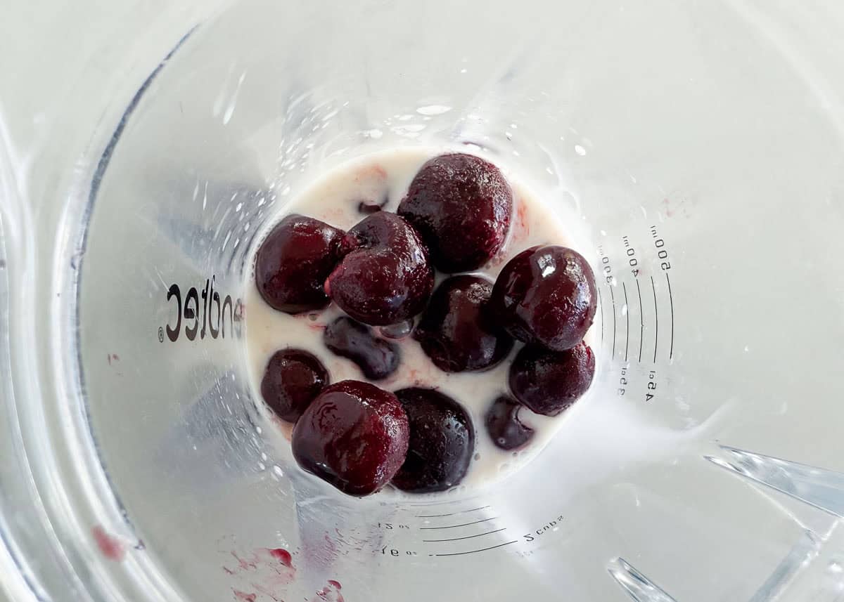 Showing how to make a cherry smoothie.