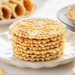 A stack of pizzelle on a plate.
