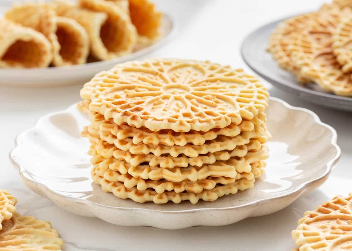 A stack of pizzelle on a plate.