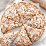 An almond cake sliced into pieces.