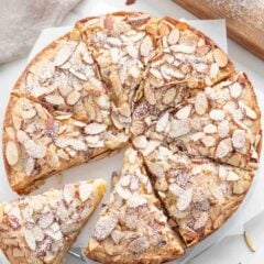 An almond cake sliced into pieces.