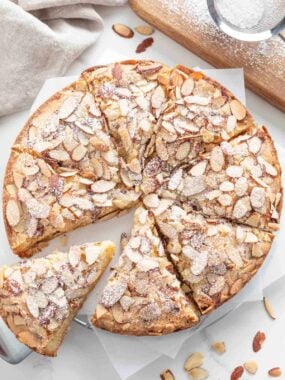 An almond cake sliced into pieces.