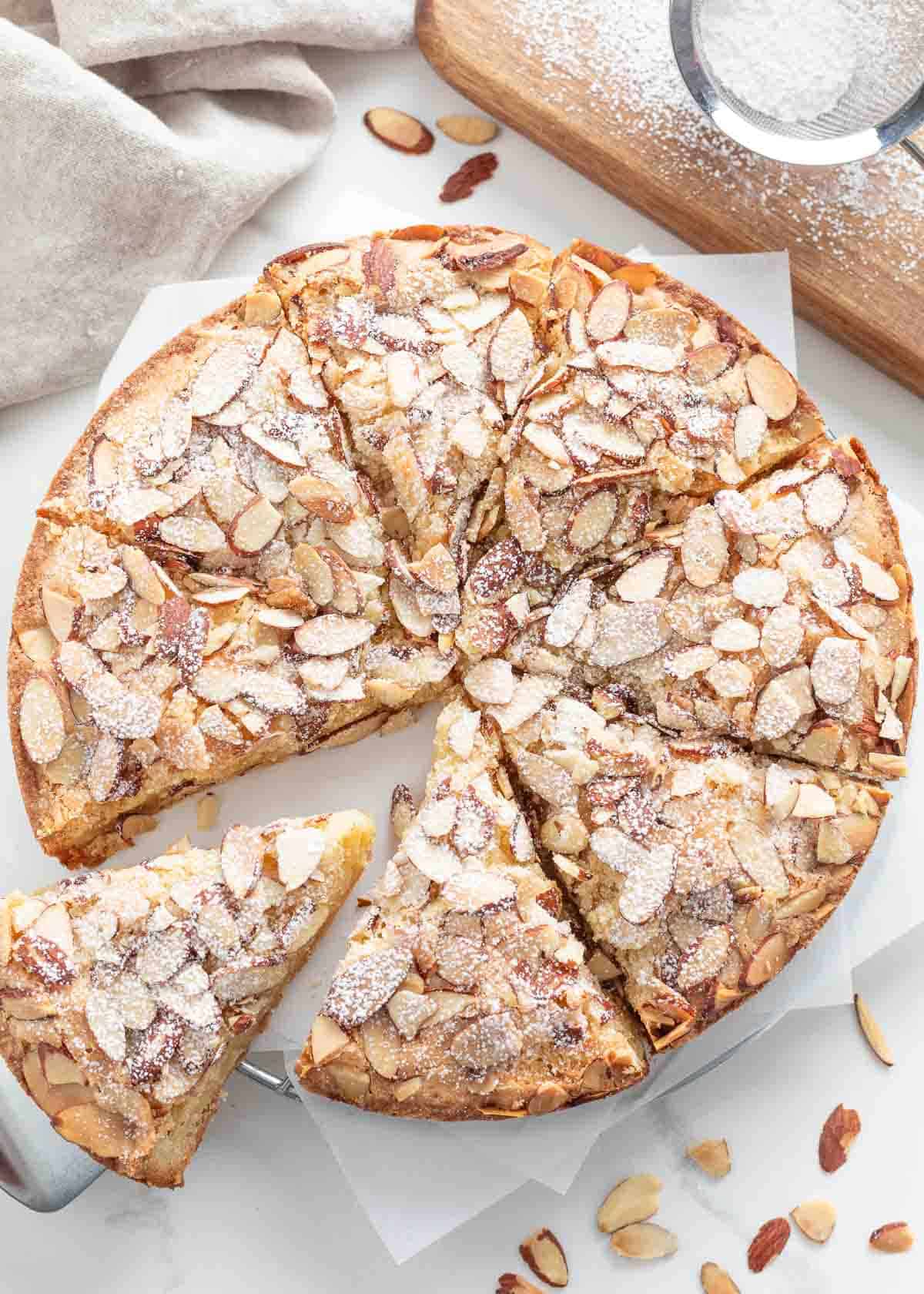 An almond cake sliced into pieces.