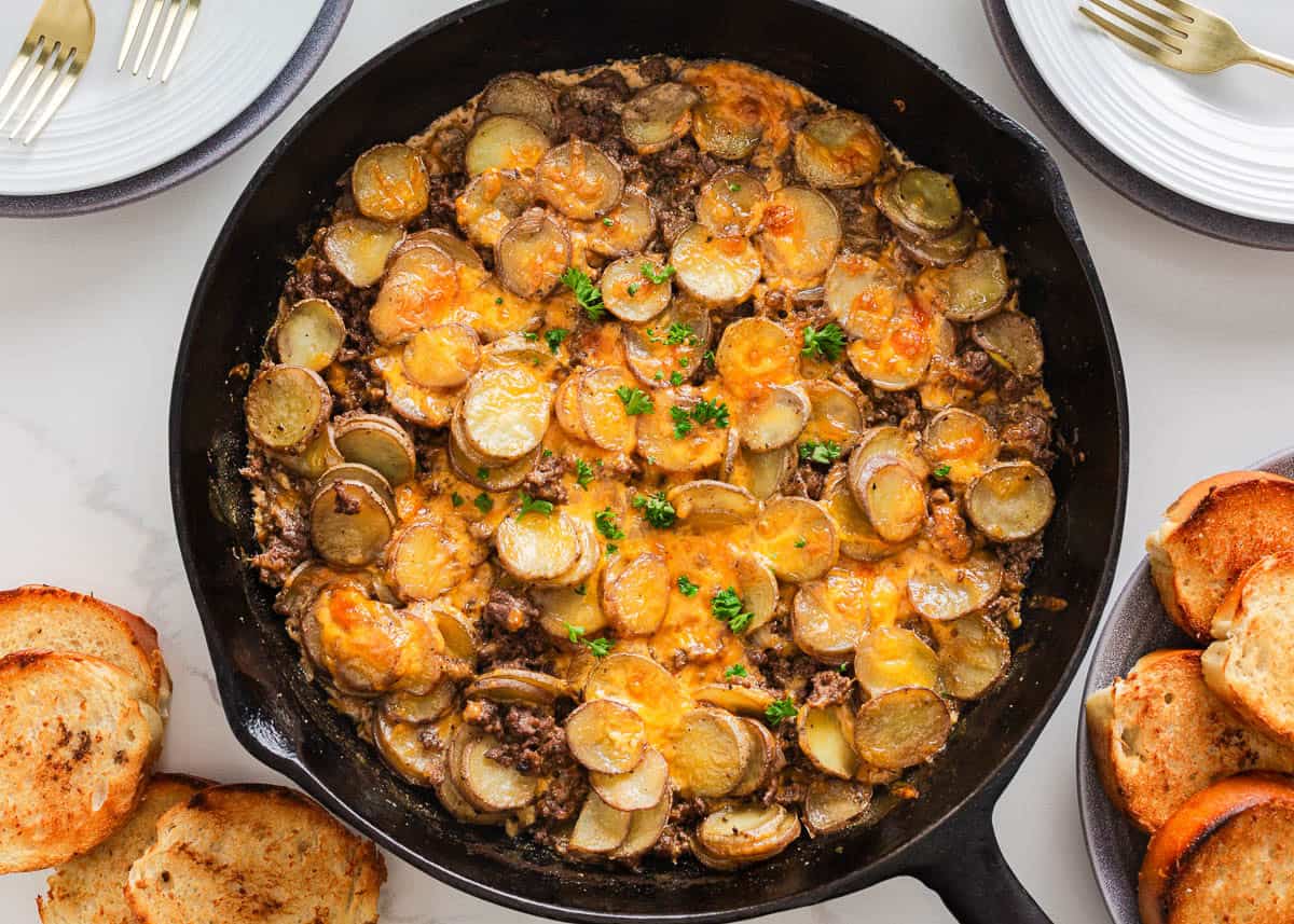 Simple yet packed with flavor, this ground beef and potatoes is an easy to make 'meat and potatoes' skillet recipe full of cheesy comfort that the whole family will love! Ground beef and potatoes in a skillet.