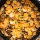 Ground beef and potatoes in a skillet.