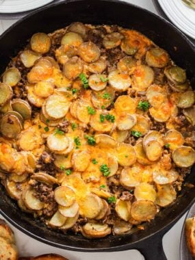 Ground beef and potatoes in a skillet.