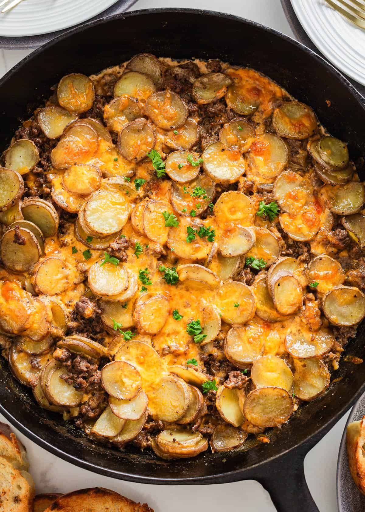 Simple yet packed with flavor, this ground beef and potatoes is an easy to make 'meat and potatoes' skillet recipe full of cheesy comfort that the whole family will love! Ground beef and potatoes in a skillet.
