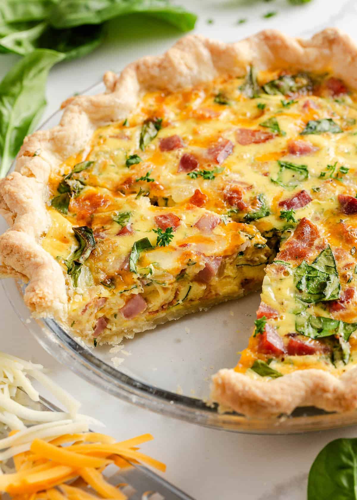 Ham and cheese quiche sliced on the counter.