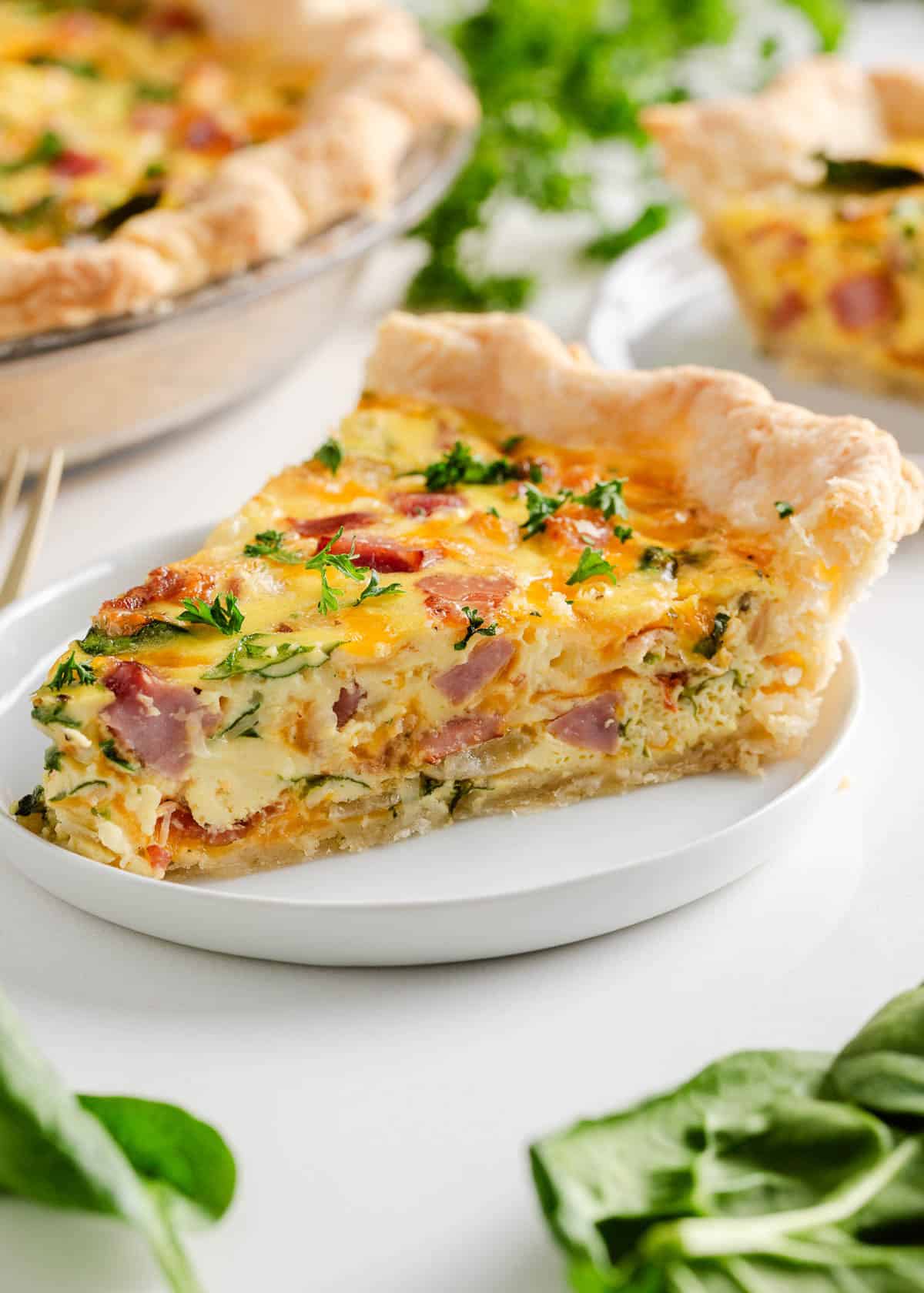 Ham and cheese quiche on a plate.