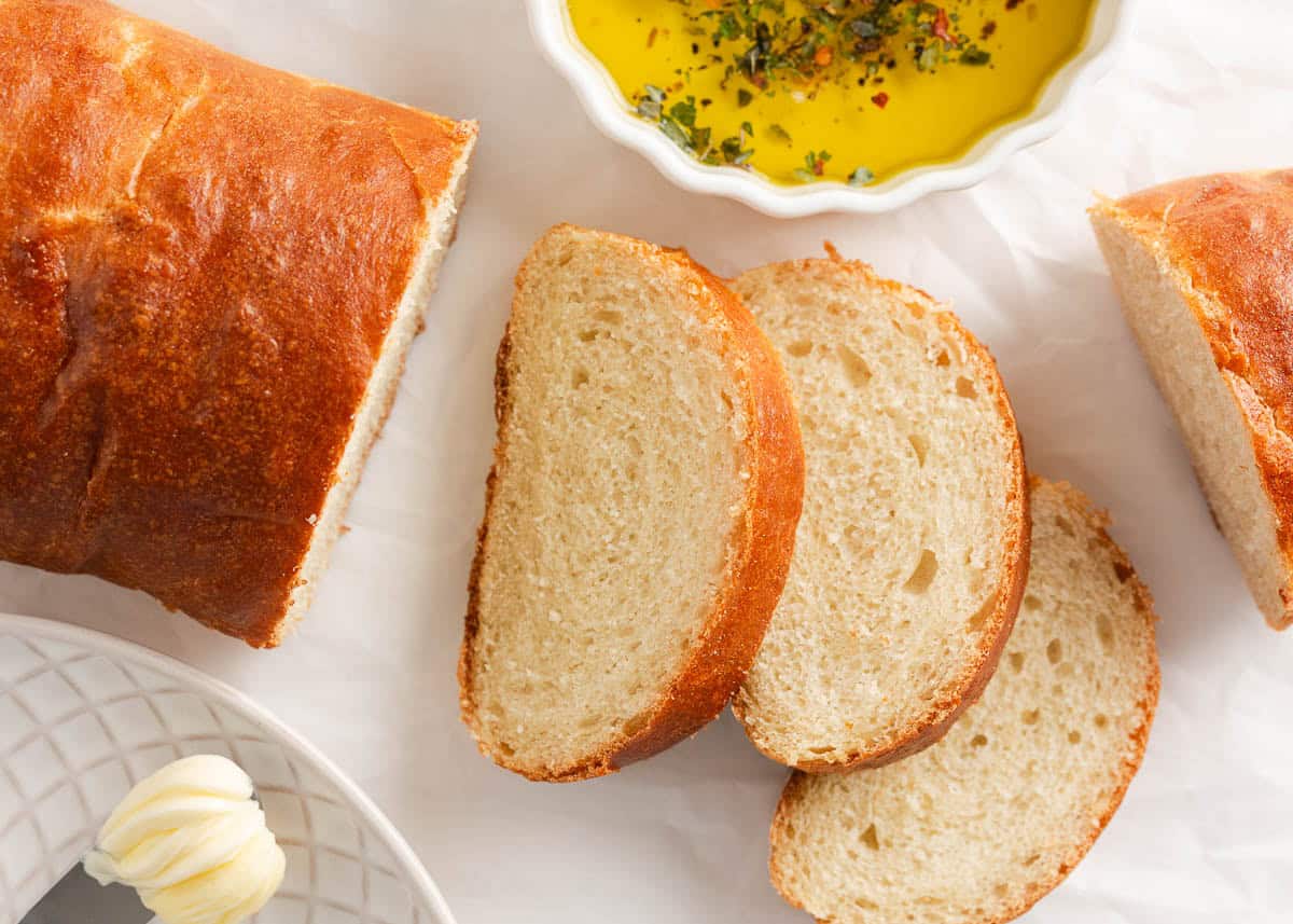 This easy Italian bread recipe is ready in just under 2 hours, including rise time. No bread maker is needed; all the kneading is done in a stand mixer, making it easier than you think! Sliced Italian bread.