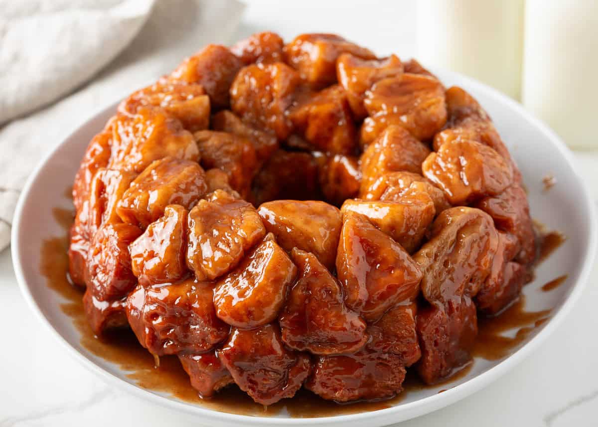 Pull-apart monkey bread is made with store-bought biscuit dough coated in cinnamon sugar then drenched in a buttery brown sugar syrup and baked in a bundt pan! Monkey bread made with Grands biscuits coated in cinnamon sugar and baked until gooey for a breakfast treat.