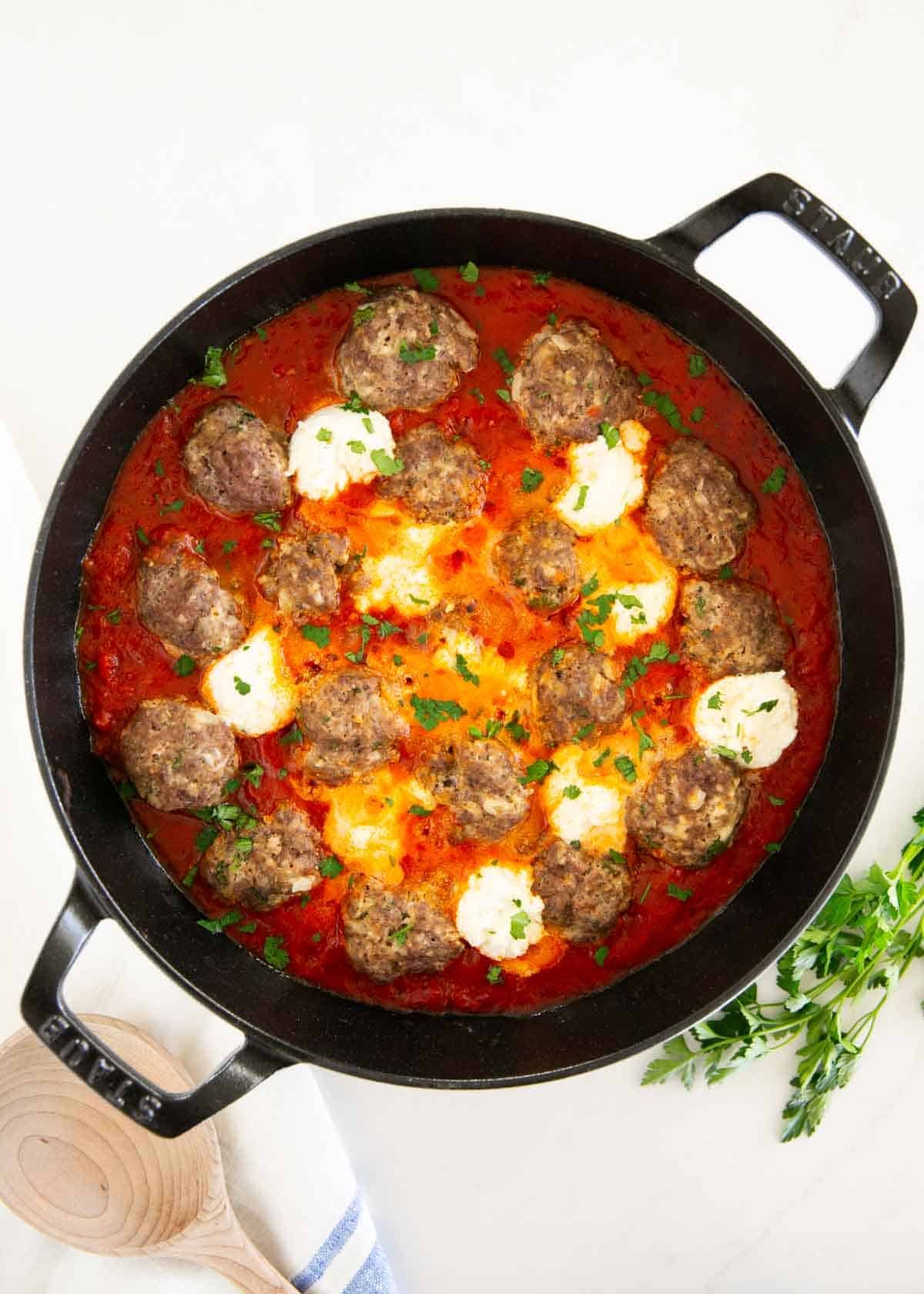 Ricotta meatballs in a skillet.