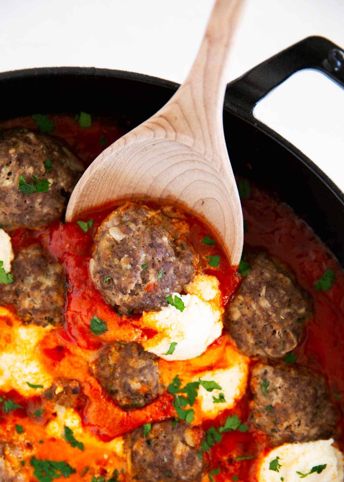 Ricotta meatballs in a skillet.