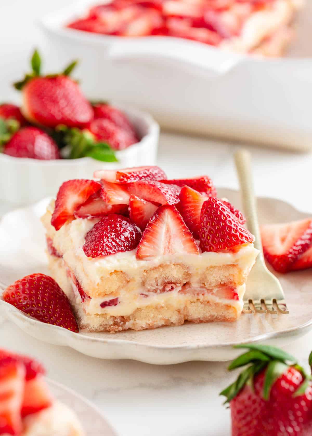 Strawberry tiramisu on a plate with a fork.