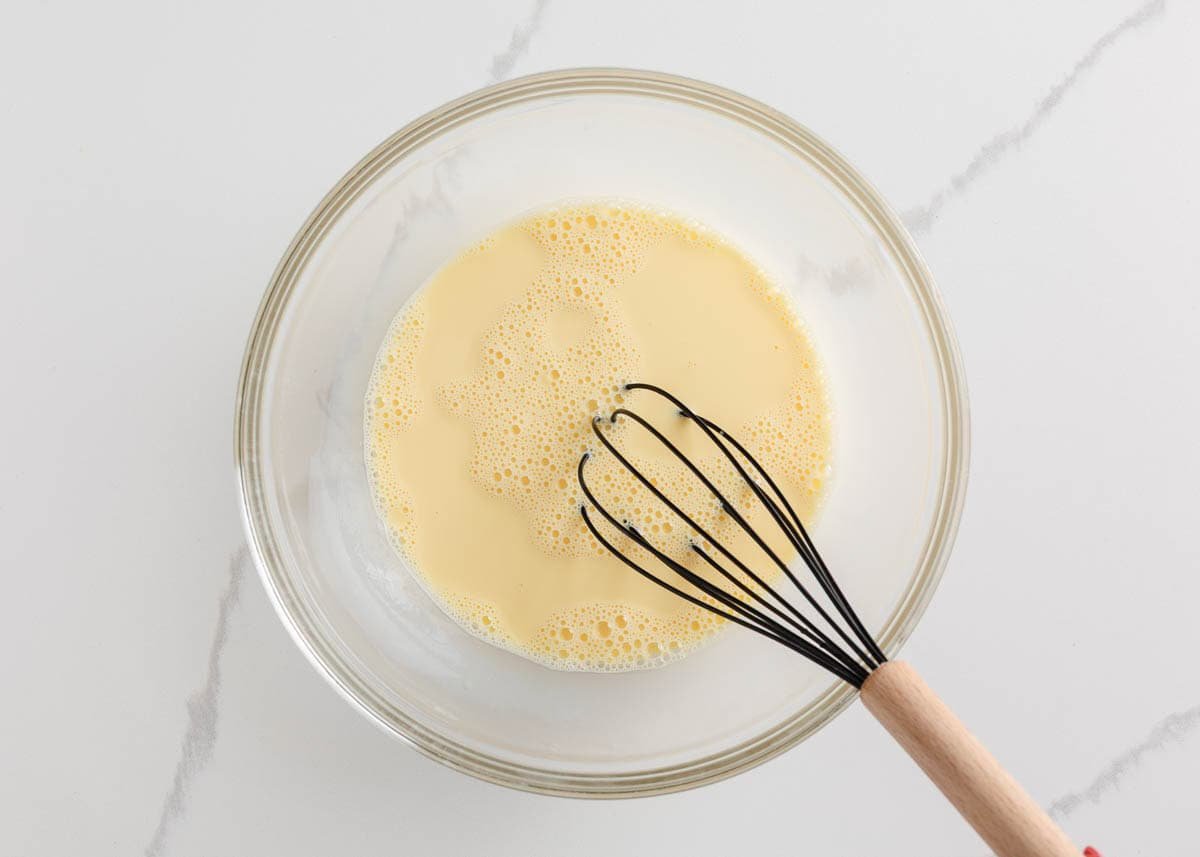 Eggs whisked in a bowl.
