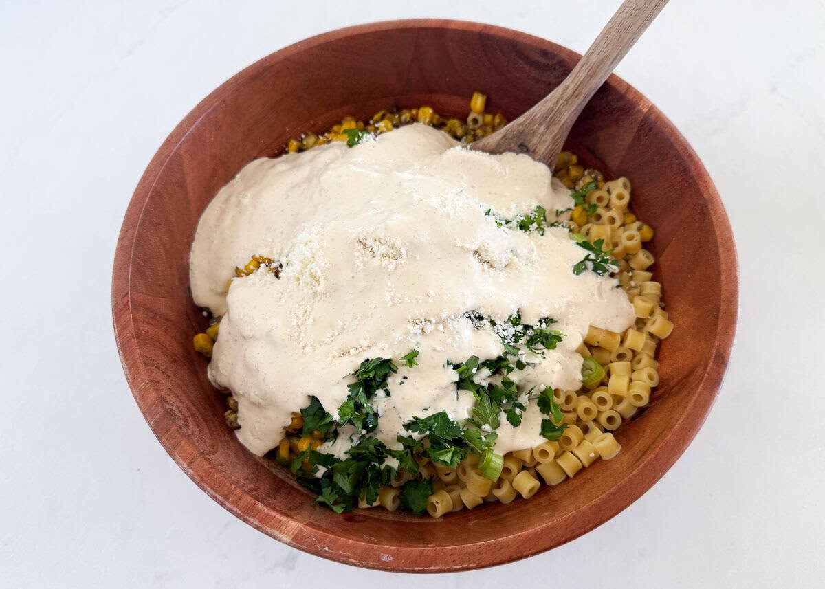 Showing how to make Mexican street corn pasta salad.