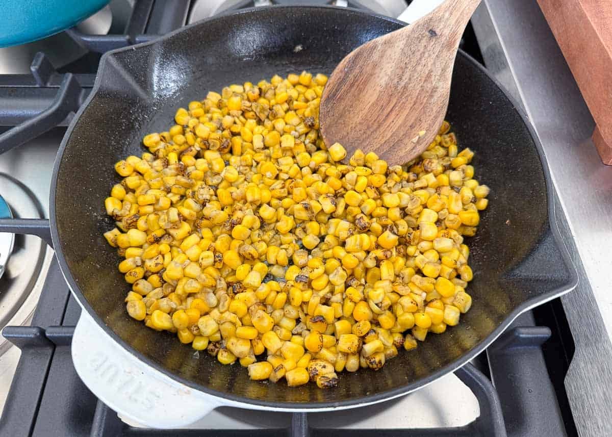Showing how to cook Mexican street corn.