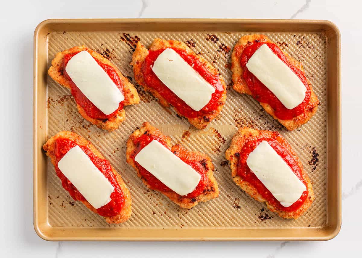 Showing how to make baked chicken parmesan.