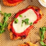 Baked chicken parmesan recipe on baking sheet.